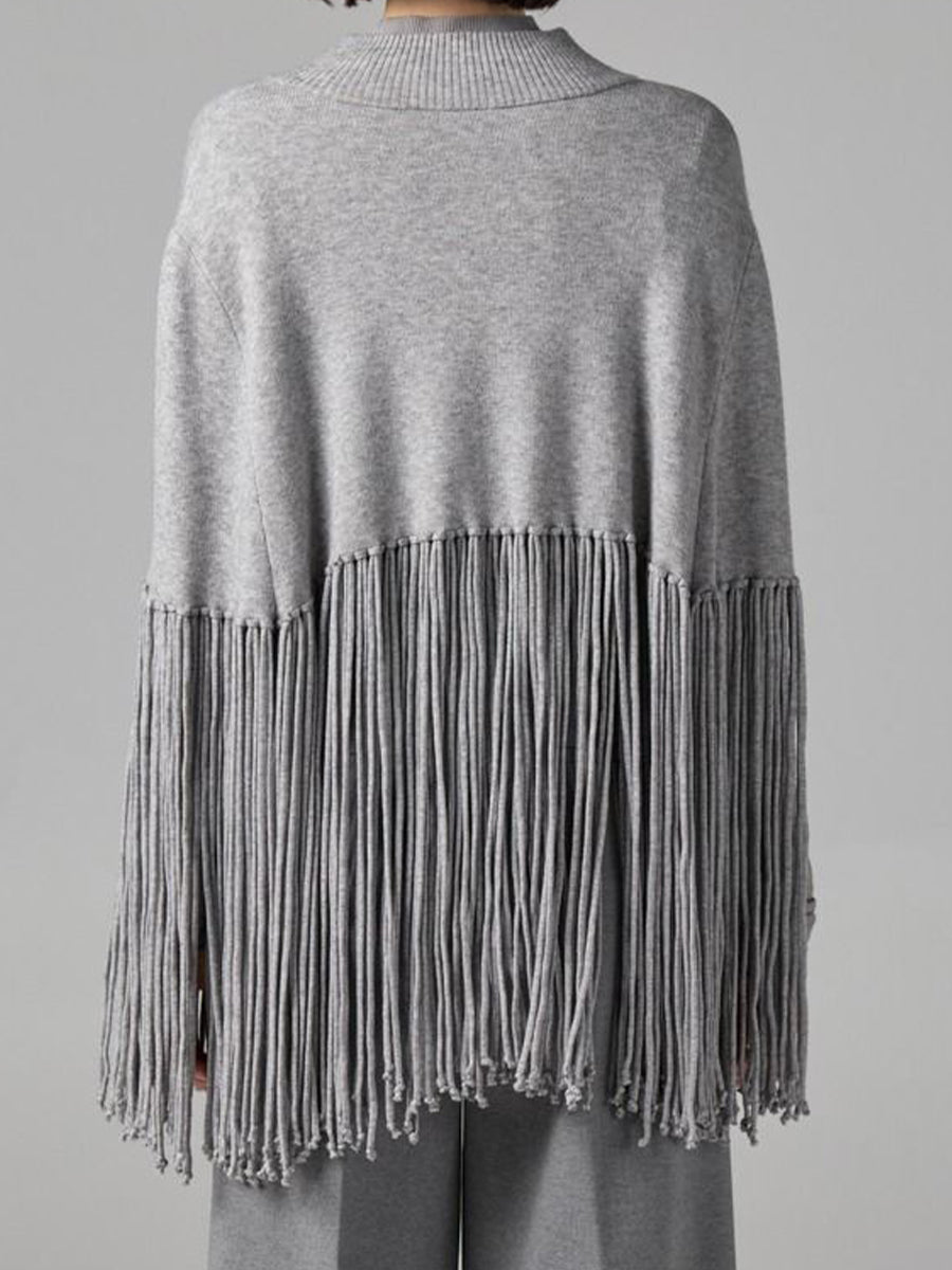 Stylish, Loose-fitting Knit Cape-style Sweater With Fringe Details.